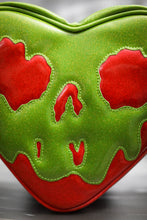 Load image into Gallery viewer, large Poisonous heart bag is made with red glitter and Green Goo. Close-up of the face. 