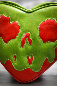 large Poisonous heart bag is made with red glitter and Green Goo. Close-up of the face. 