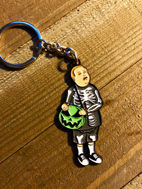 Boy in a skeleton costume with a pumpkin bag keychain 