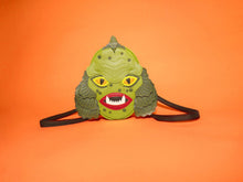 Load image into Gallery viewer, swamp monster backpack on orange background