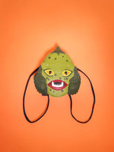 Load image into Gallery viewer, swamp monster backpack on orange background